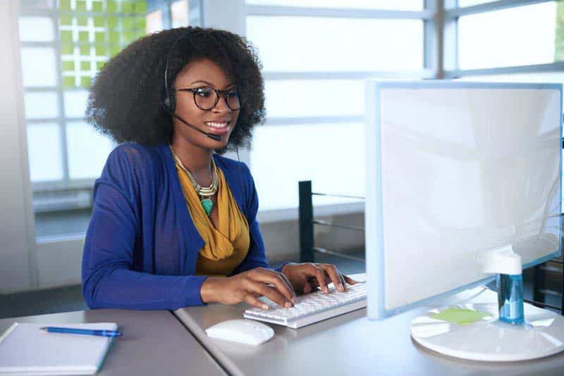 smiling customer service representative assisting a customer